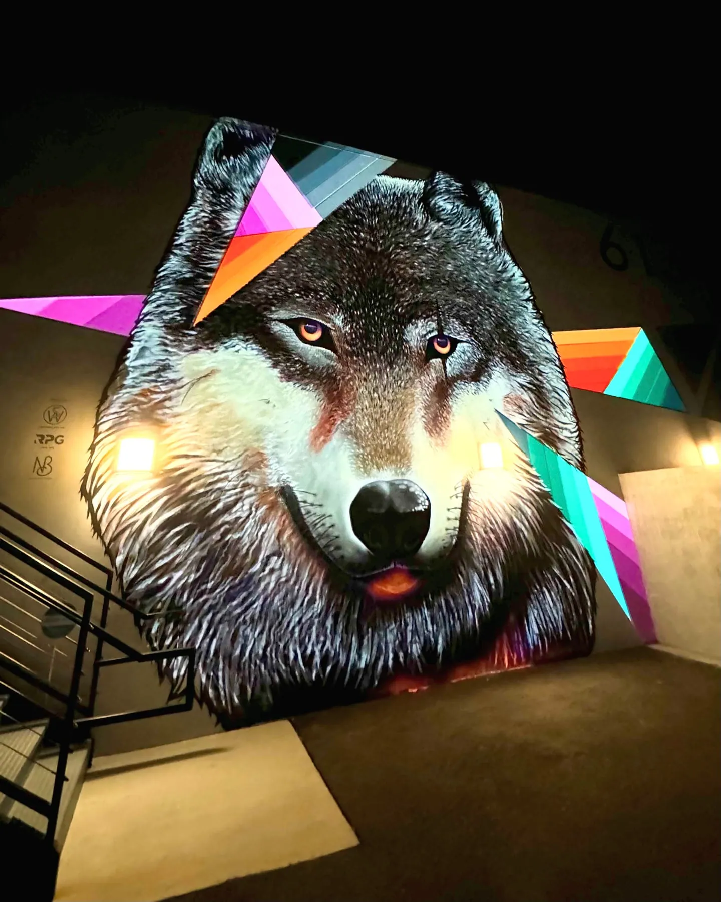 Wolf mural with subtle projected highlights at night